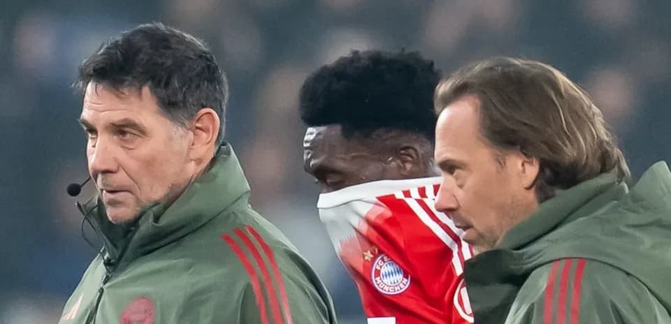 Bayern Munich staff assisting player during match