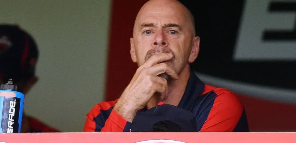 Coach observing from the team box during match