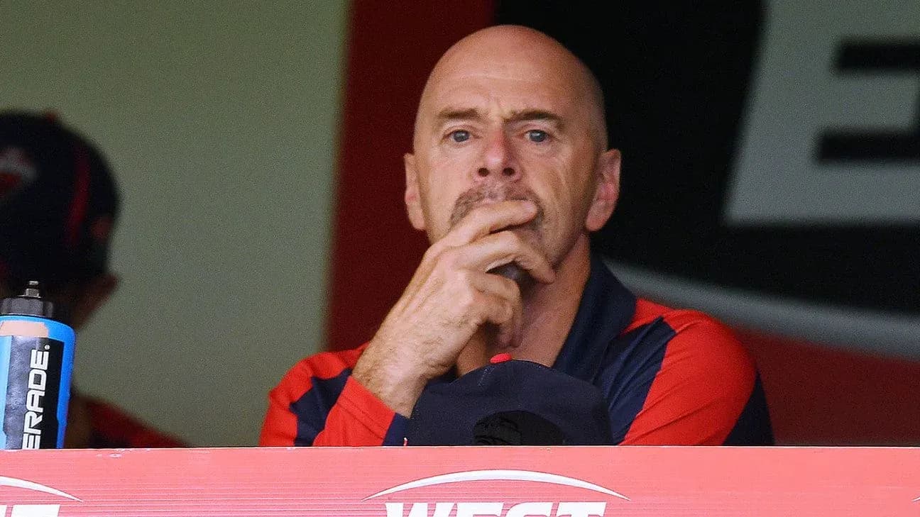 Coach observing from the team box during match