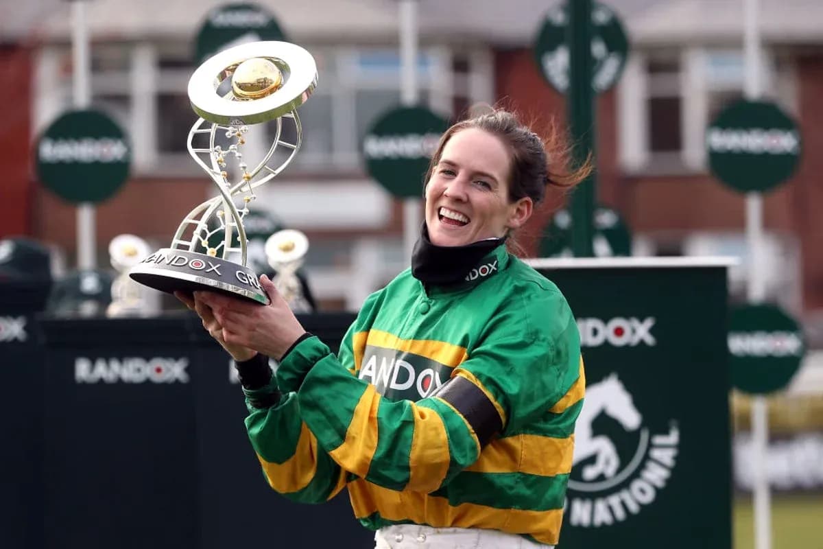 Jockey celebrating with trophy after winning race