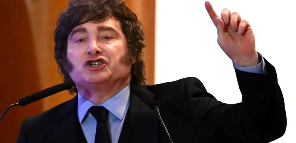 Speaker gesturing passionately at podium during speech