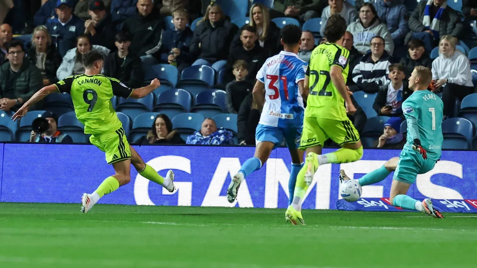 Player shooting at goal with goalkeeper approaching