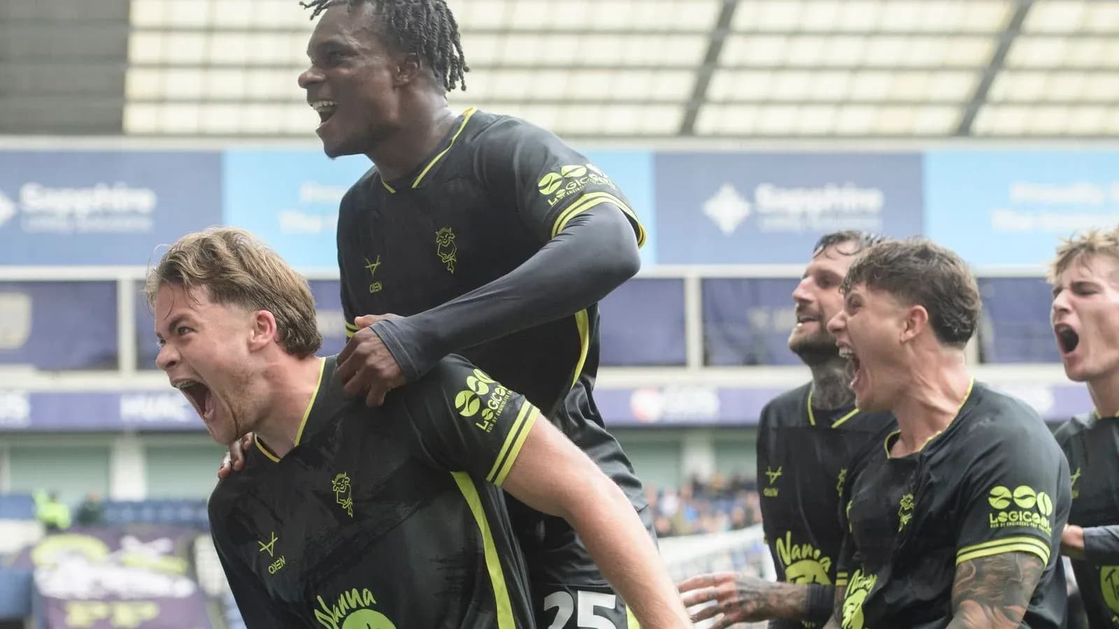 Players celebrating a goal during a football match
