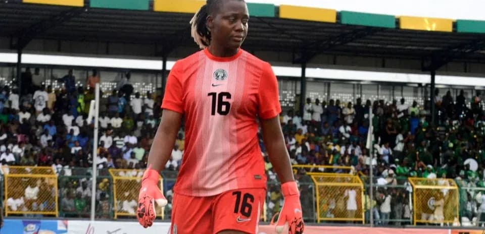 Goalkeeper in red kit walking off the field
