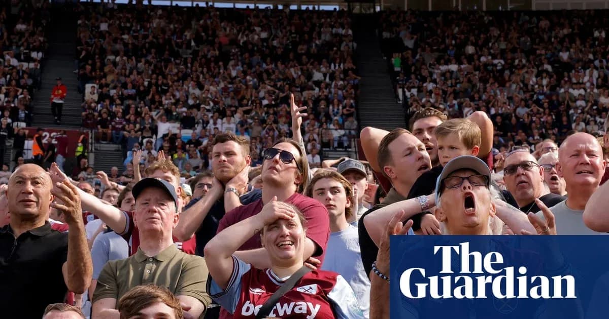Crowd reacting during a football match at stadium