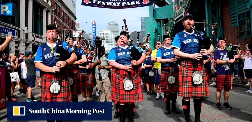 Bagpipe players in kilts marching outside Fenway Park