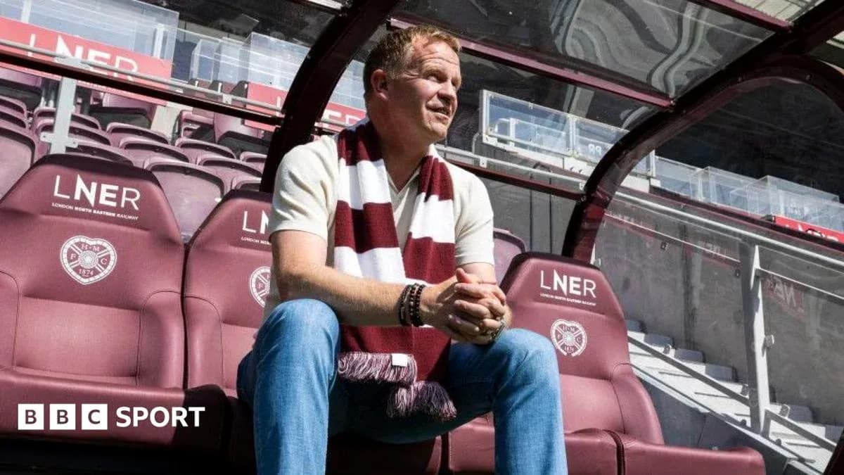 Men sitting on team bench wearing club scarf