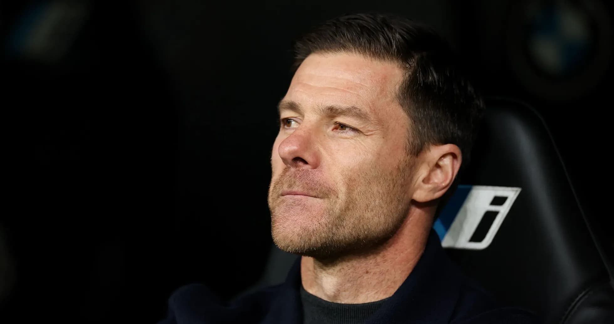 Coach sitting on bench during match
