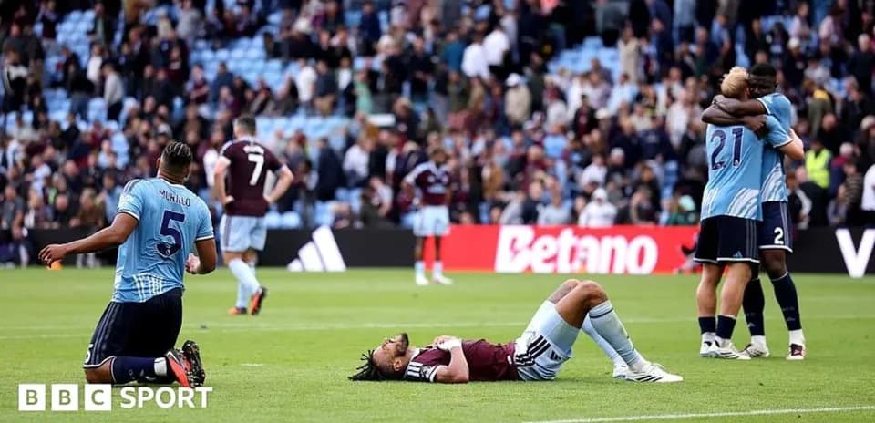 Players reacting after the match, one lying down