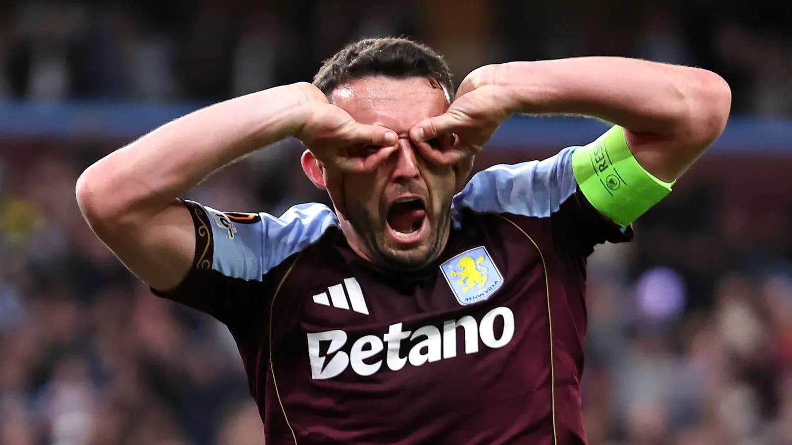 Aston Villa player celebrating with hand gestures
