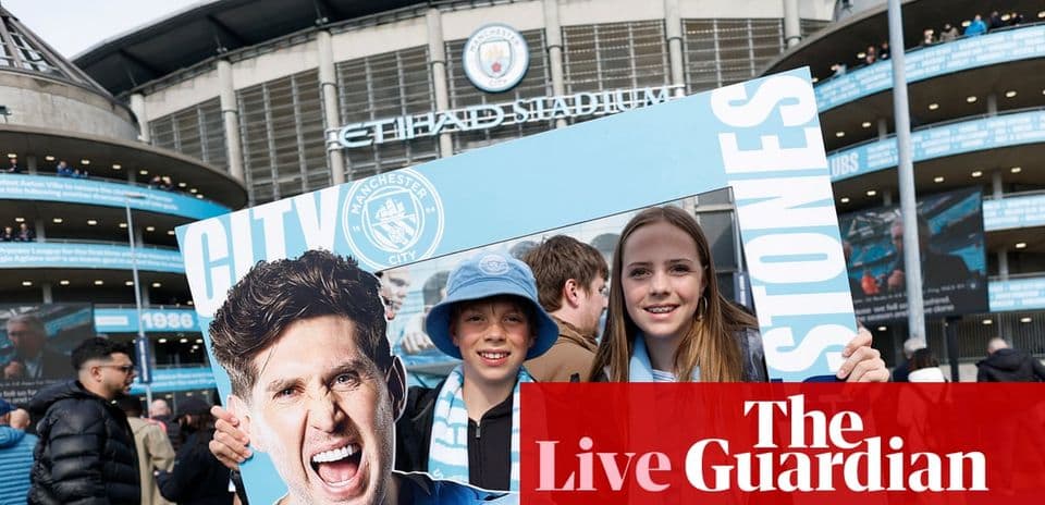 Children holding Manchester City sign outside stadium