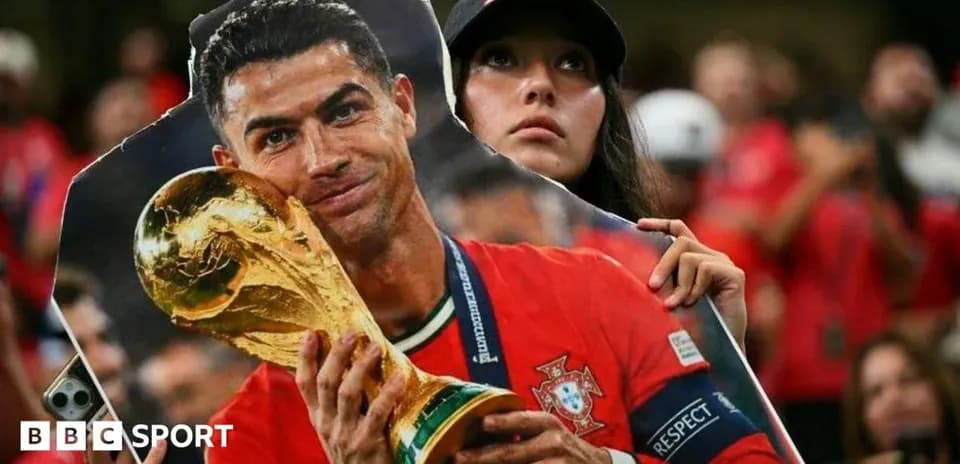 Fan holding Ronaldo cutout with World Cup trophy