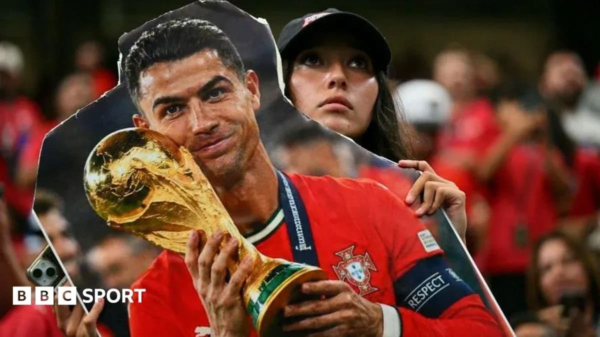 Fan holding Ronaldo cutout with World Cup trophy
