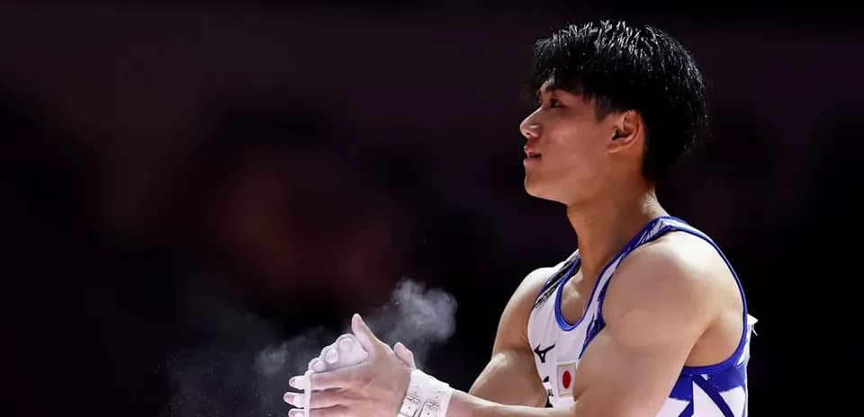 Gymnast applying chalk before performance