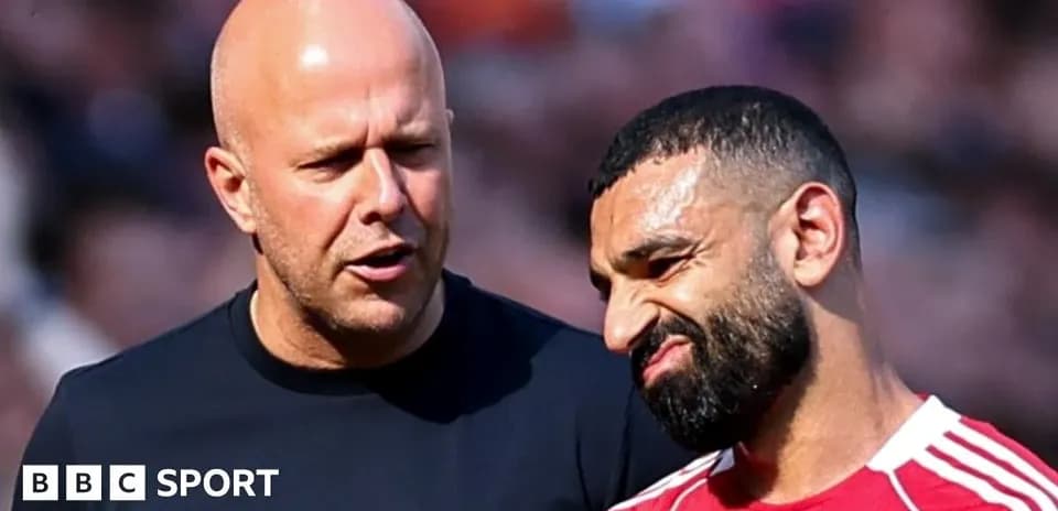 Two men talking on the football field