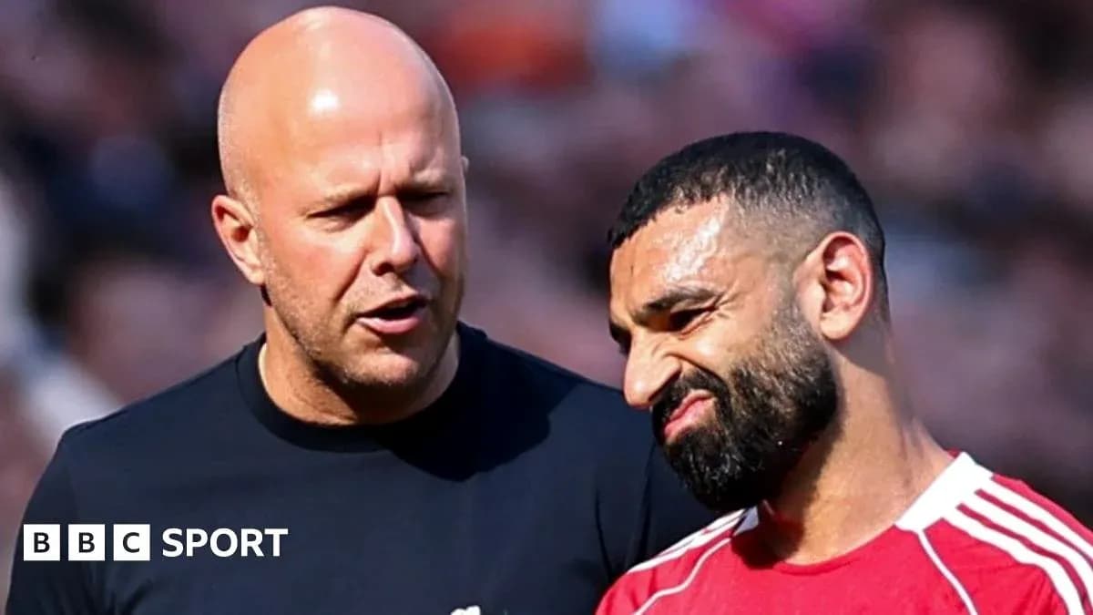 Two men talking on the football field