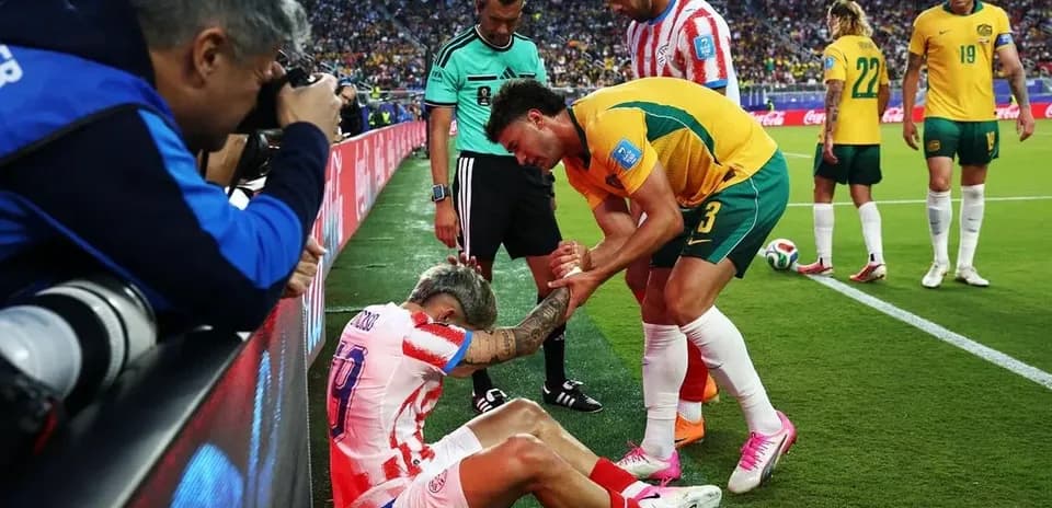 Player receiving assistance from teammates on field