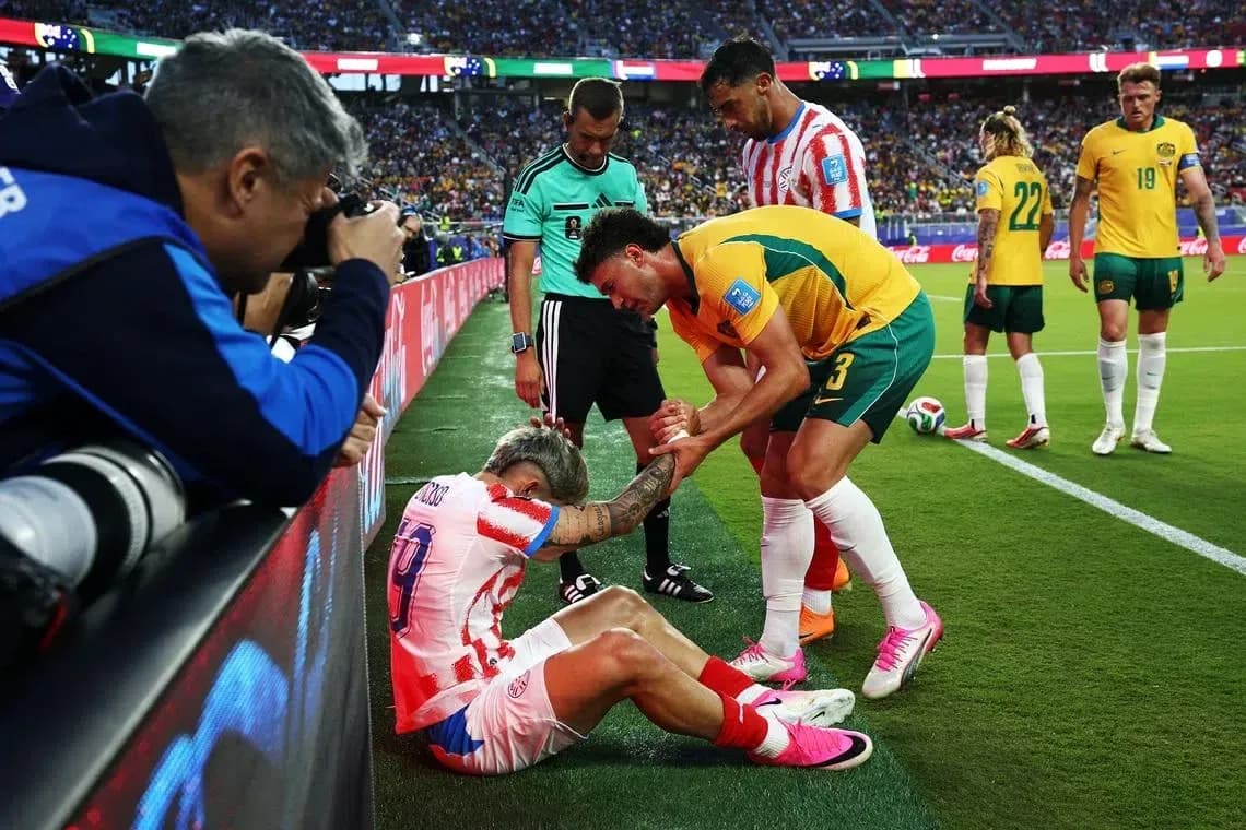 Player receiving assistance from teammates on field