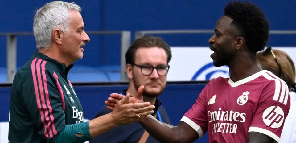 Coach and player shaking hands during training session
