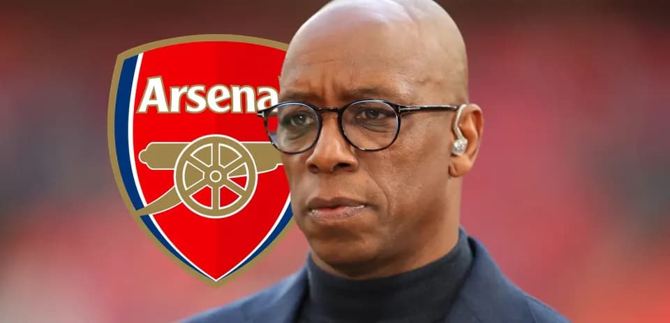 Analyst in front of Arsenal logo during broadcast