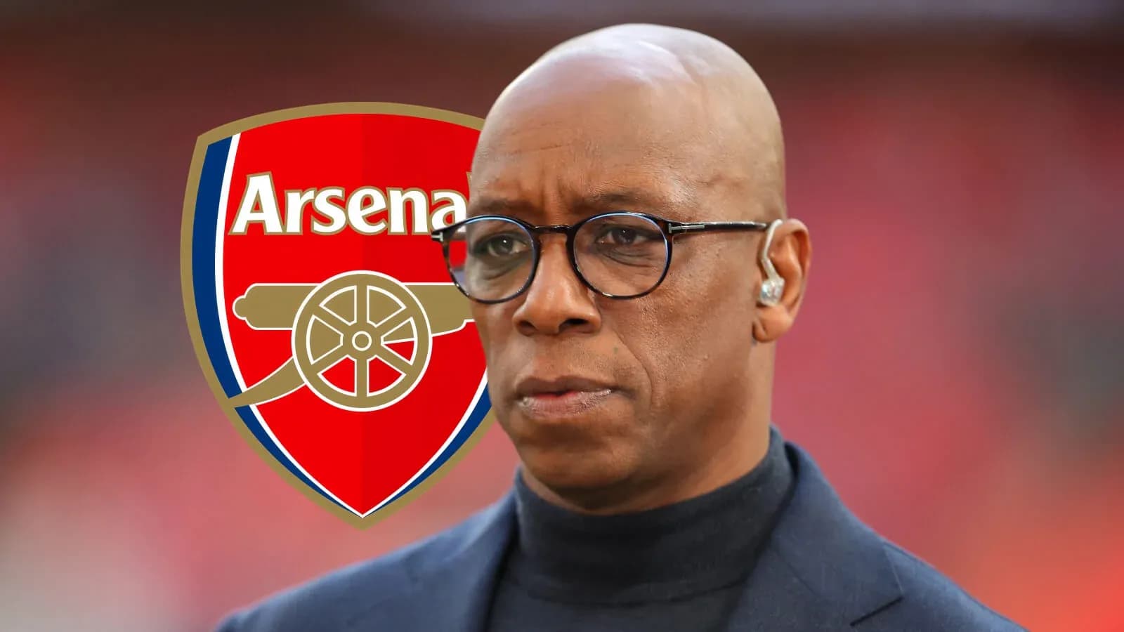 Analyst in front of Arsenal logo during broadcast