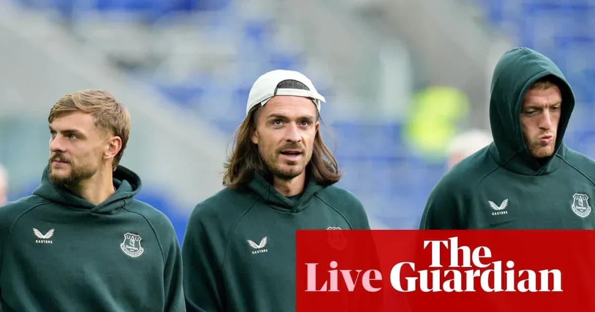 Three players walking in Everton training gear