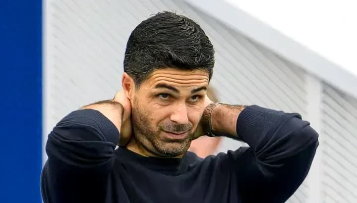 Football manager adjusting his collar during training