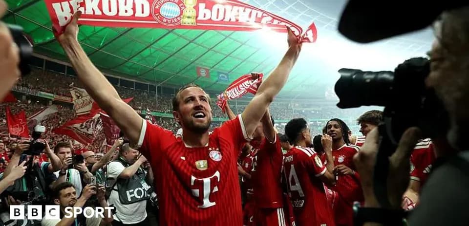 Bayern Munich player celebrating with fans holding scarf