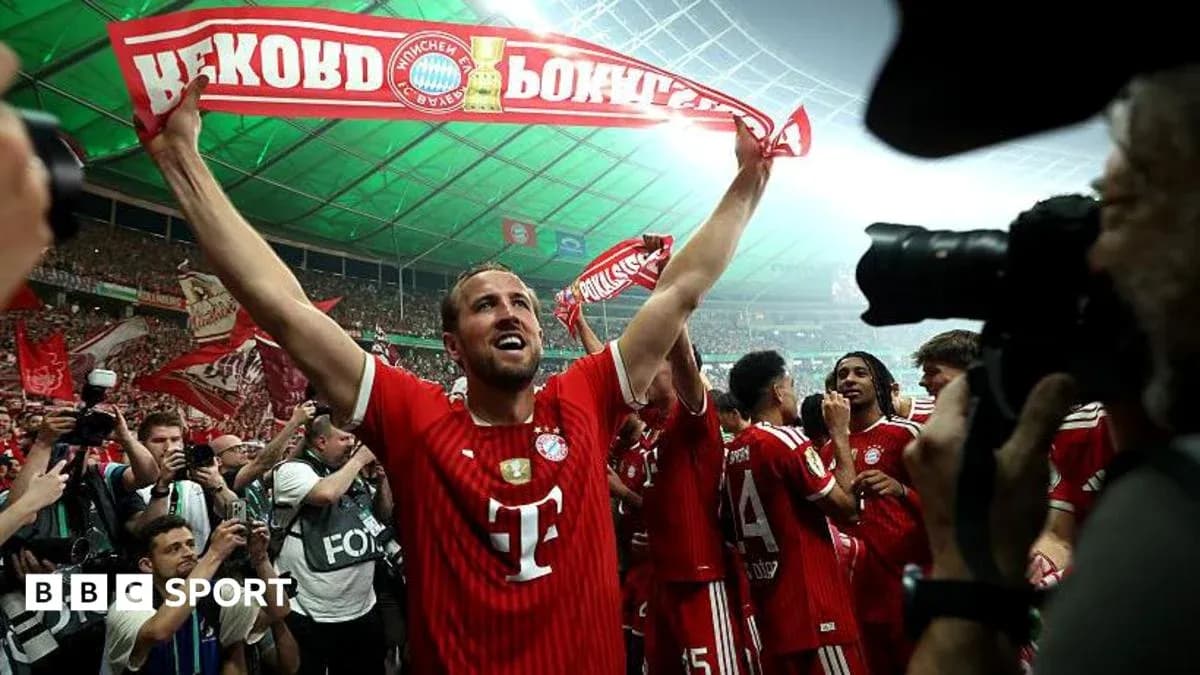 Bayern Munich player celebrating with fans holding scarf