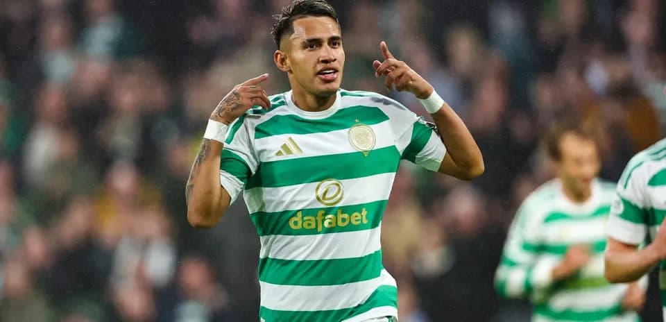 Celtic player celebrating goal with fans