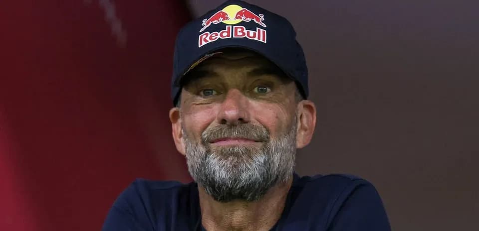Man with a beard wearing a Red Bull cap