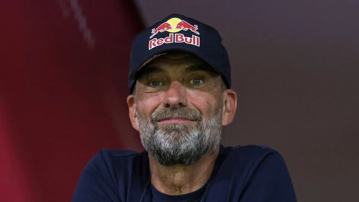 Man with a beard wearing a Red Bull cap