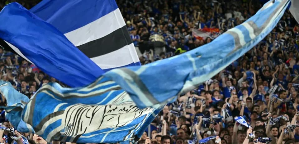 Fan celebration with flags and scarves in stadium