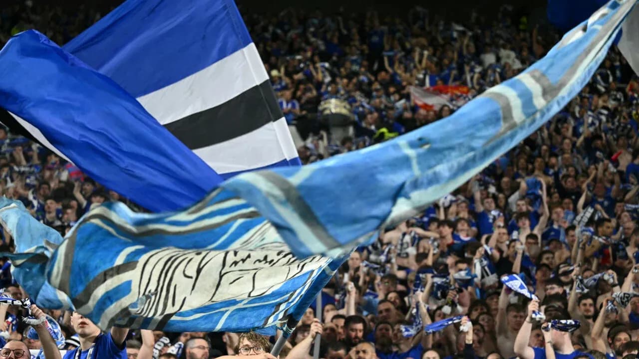 Fan celebration with flags and scarves in stadium