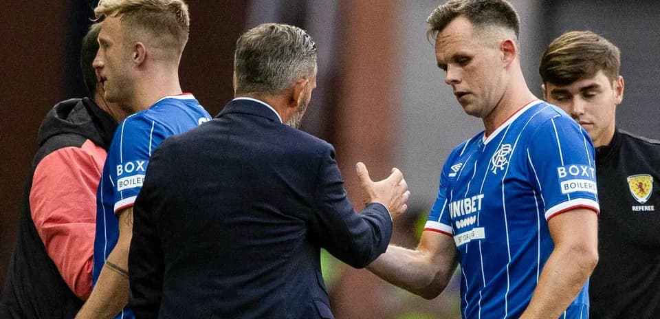 Rangers players interacting with coach during match