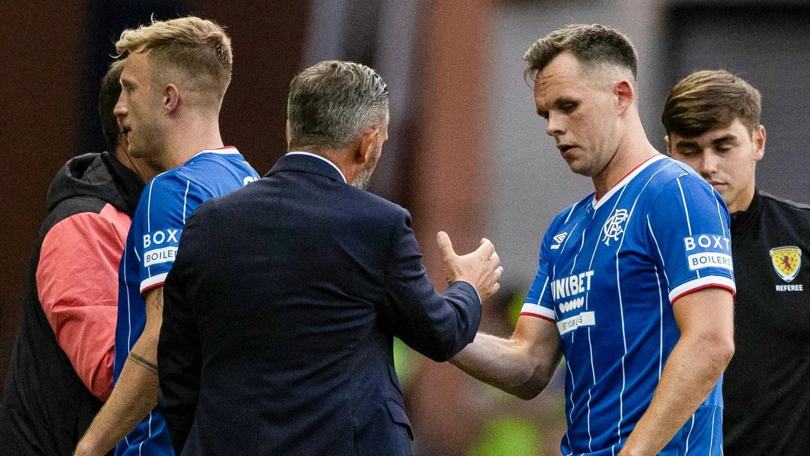 Rangers players interacting with coach during match