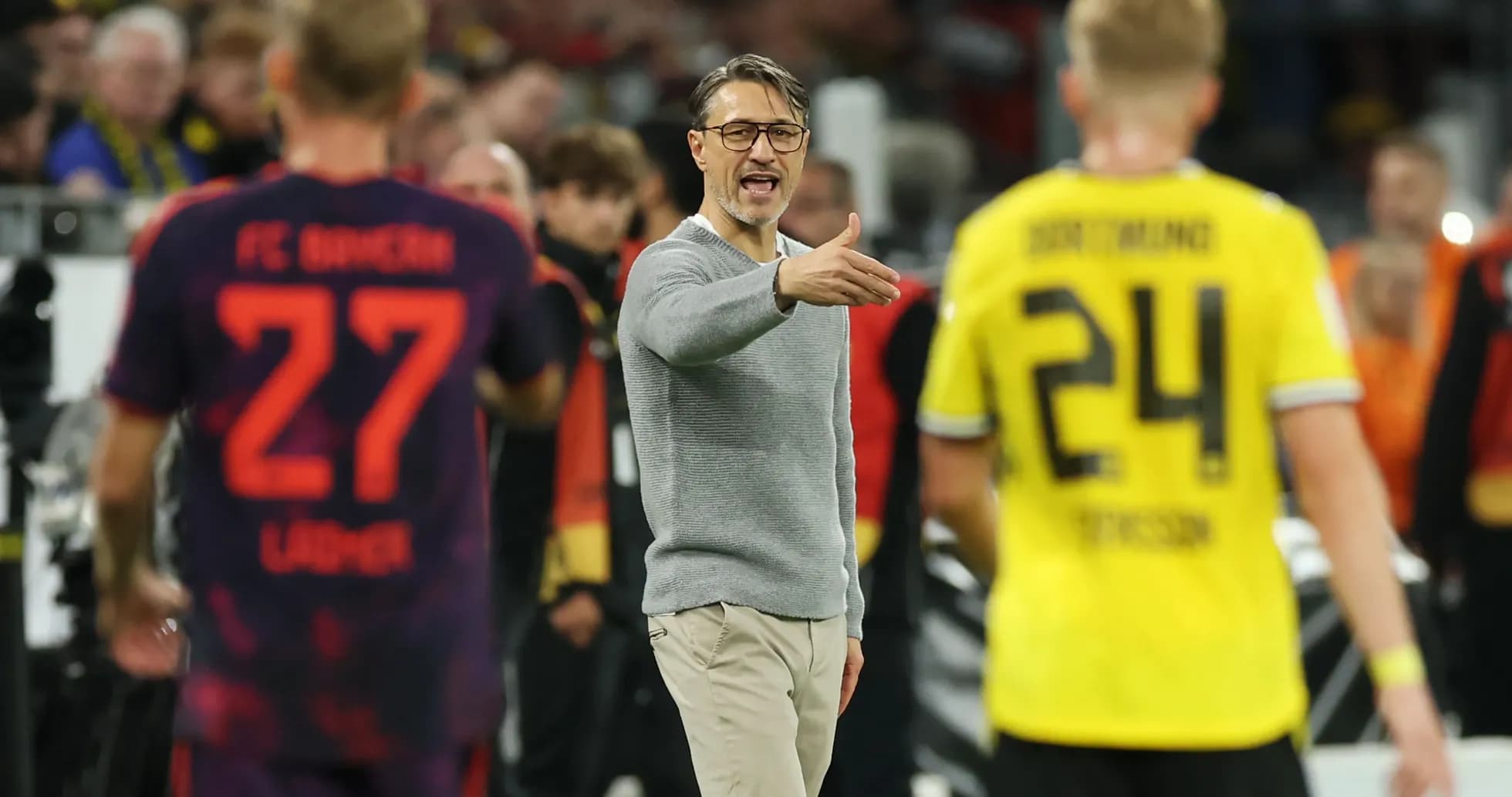 Coach gesturing during match with players nearby