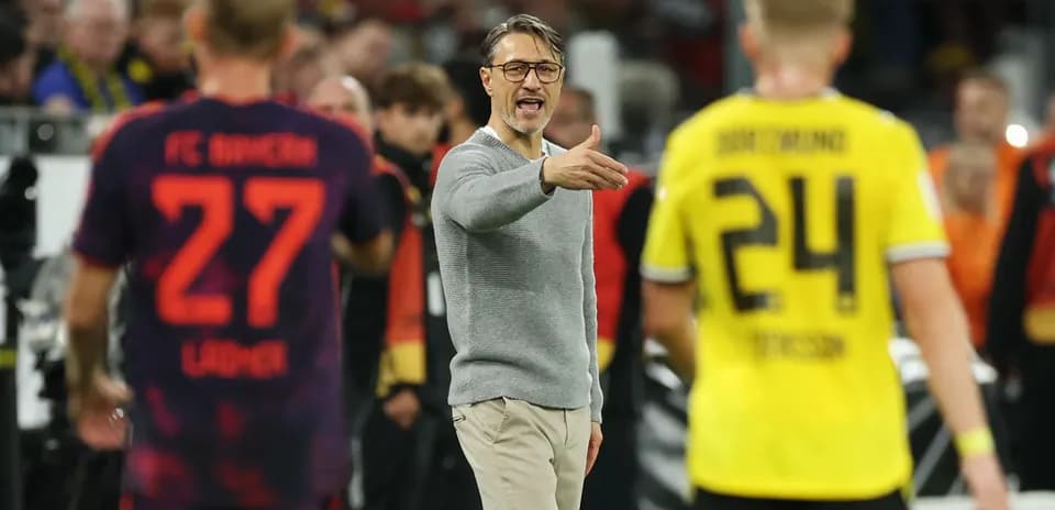 Coach gesturing during match with players nearby