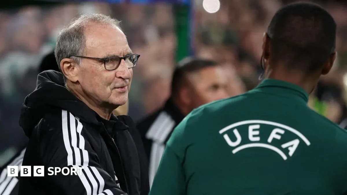 Coach interacting with UEFA official on sidelines