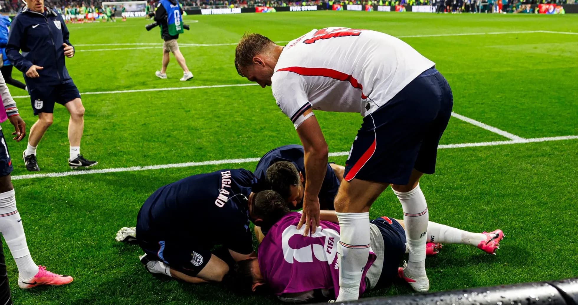 Players and staff attending to an injured teammate