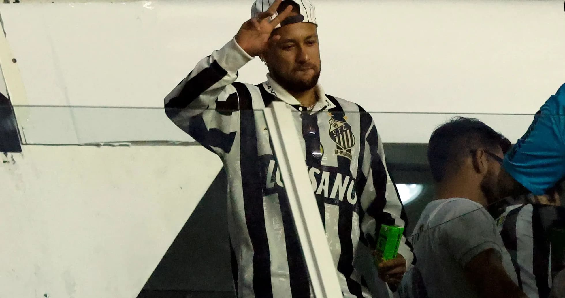 Neymar waving while wearing Santos FC jersey