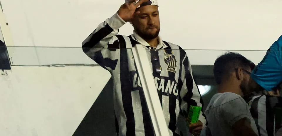 Neymar waving while wearing Santos FC jersey