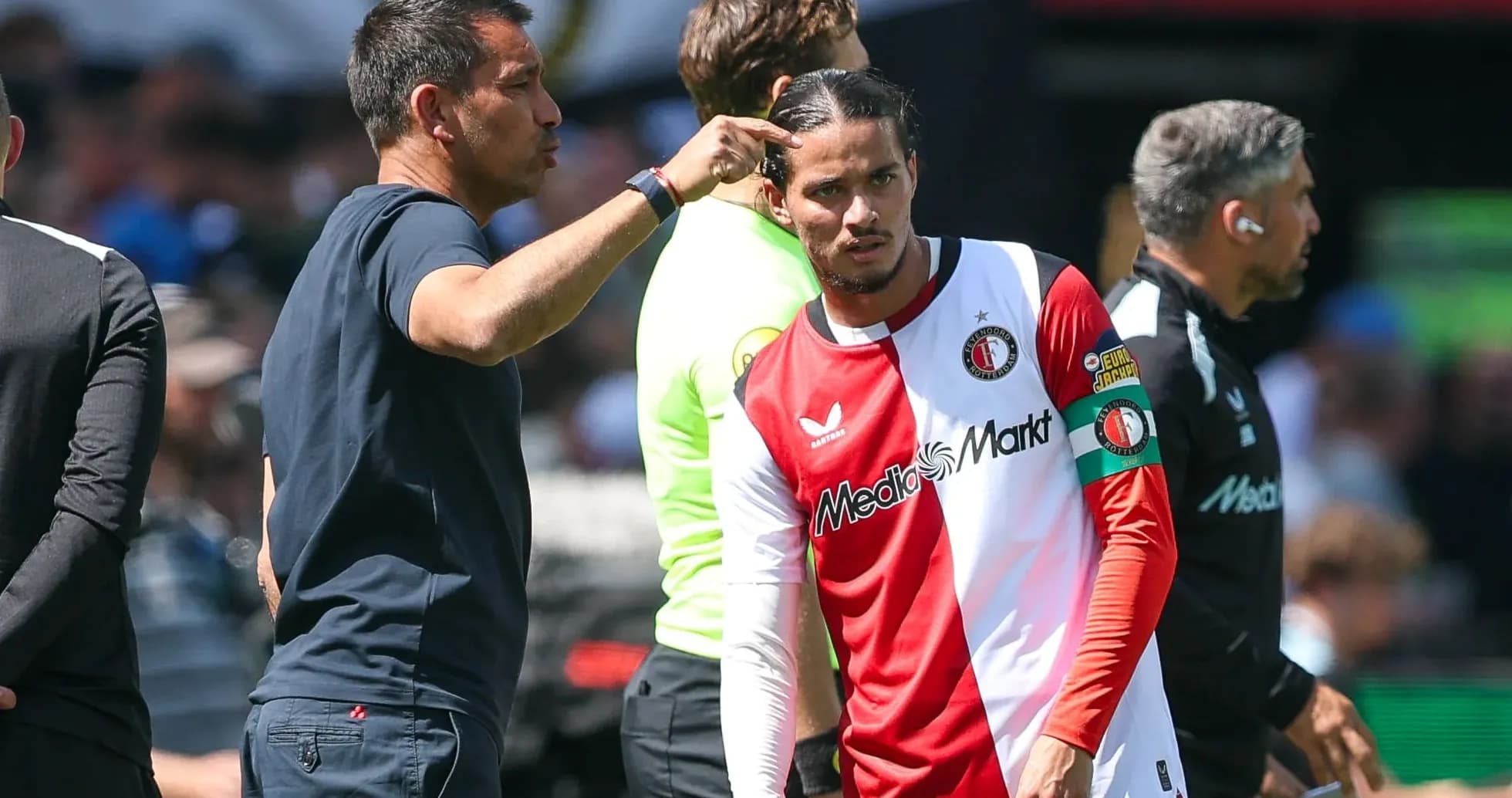Feyenoord coach instructing player during substitution