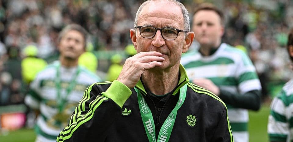 Coach with glasses on field during celebration