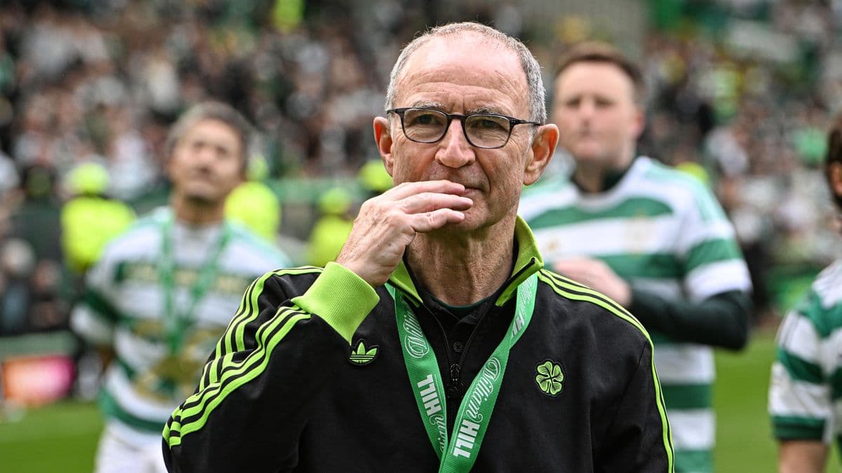 Coach with glasses on field during celebration