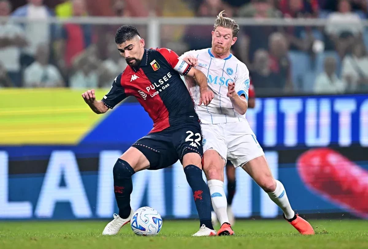 Genoa player challenged by Napoli opponent during match