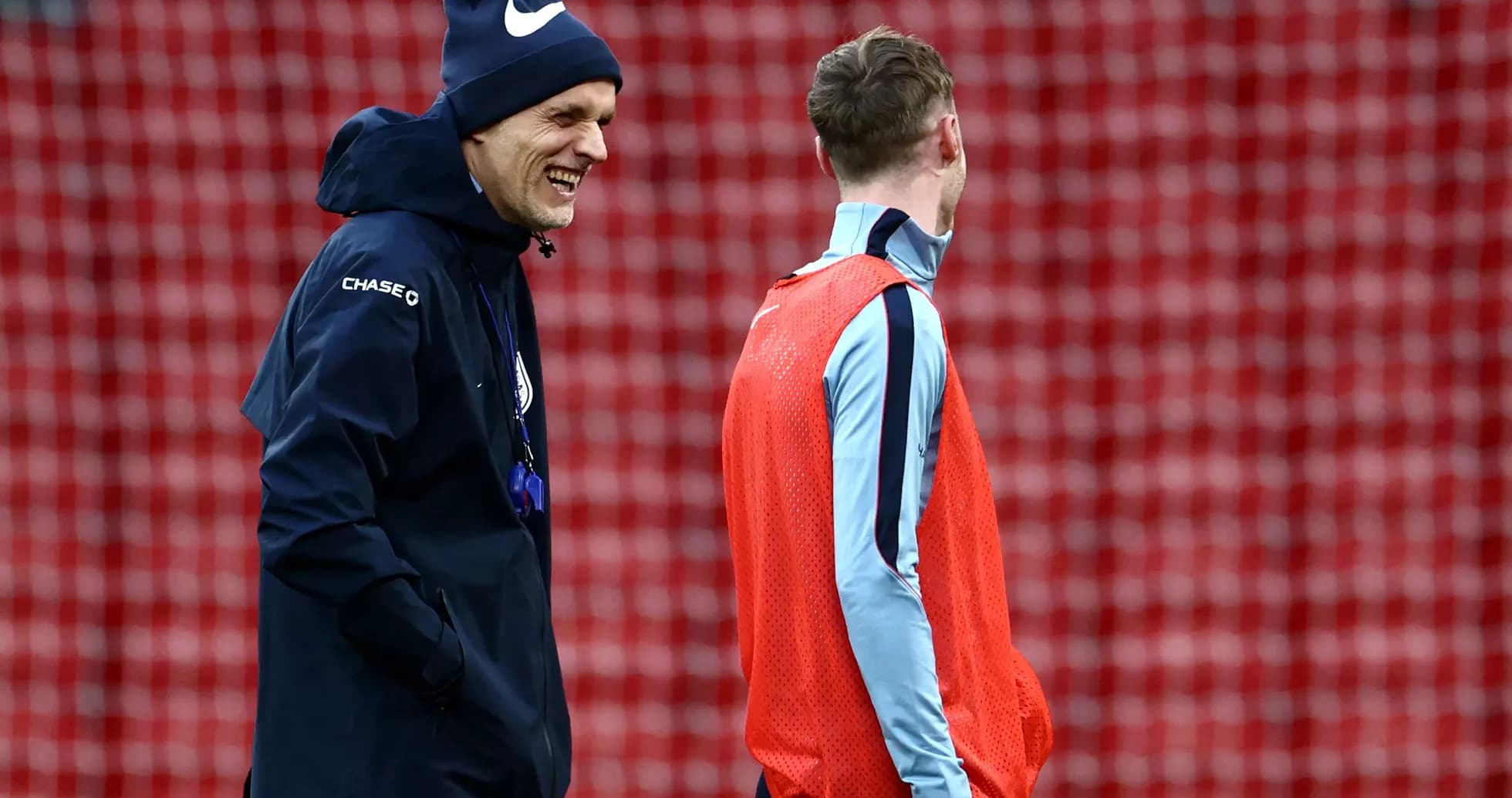 Coach and player laughing during training session