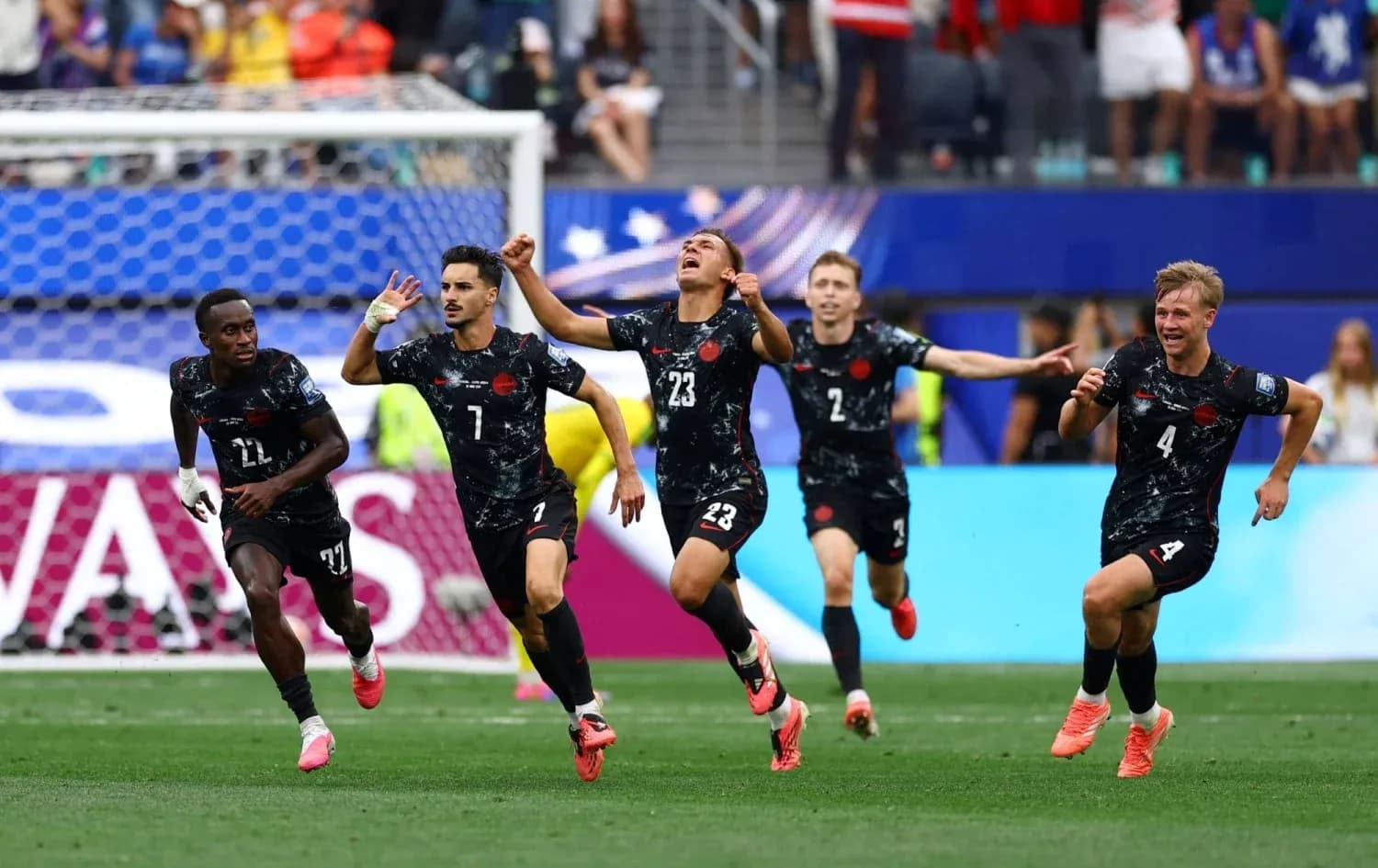 Players celebrating a goal during a match