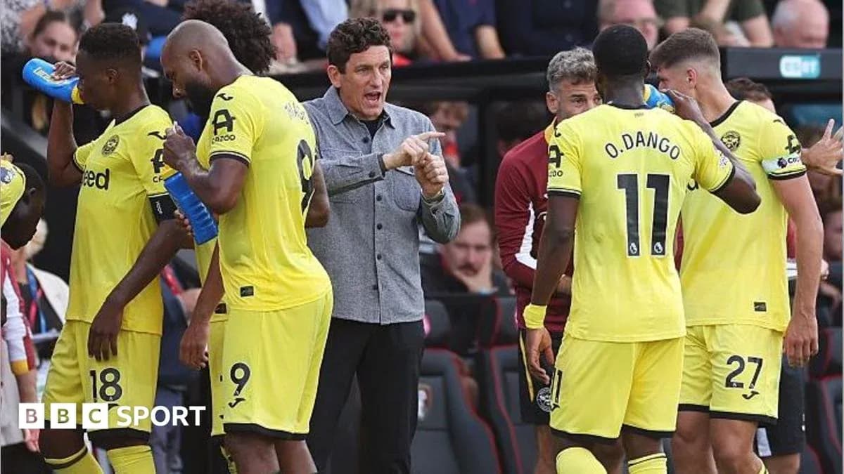 Brentford players and coach discussing during match