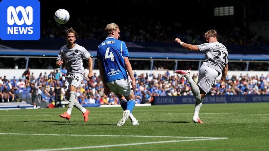 Player kicking ball during football match action